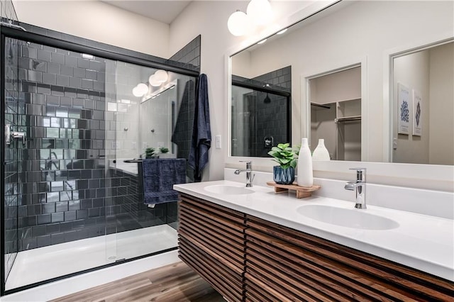 4413 E 135th St, Grandview, MO 64030 - bathroom featuring a shower stall, wood finished floors, and double vanity