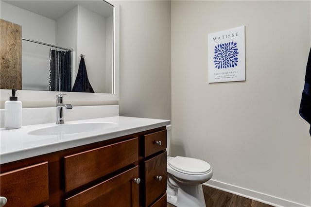 4413 E 135th St, Grandview, MO 64030 - bathroom featuring wood finished floors, baseboards, vanity, toilet, and a shower with shower curtain