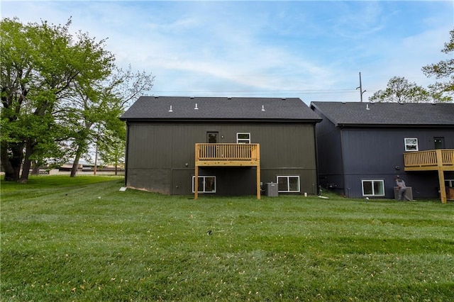 4413 E 135th St, Grandview, MO 64030 - rear view of property featuring a yard, central AC unit, and a deck