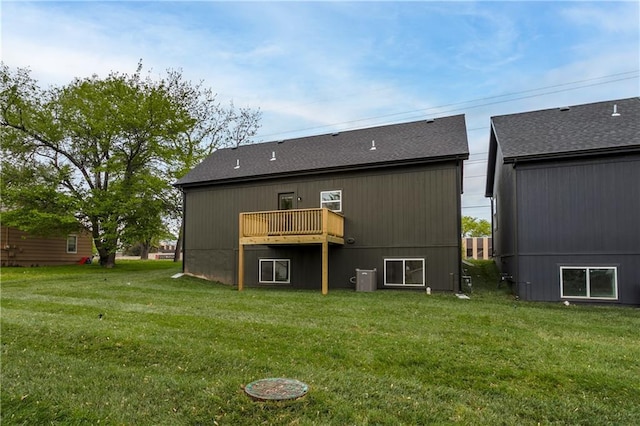 4413 E 135th St, Grandview, MO 64030 - back of property featuring a yard, a deck, and a shingled roof