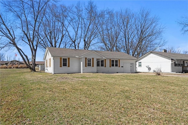 ranch-style home with a front lawn and an attached garage