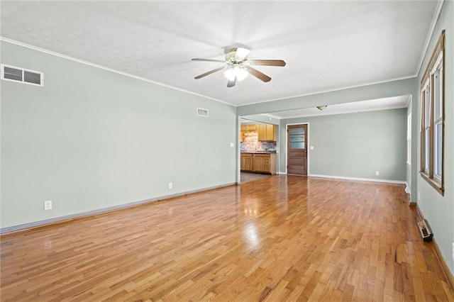 unfurnished living room featuring baseboards, visible vents, light wood finished floors, ceiling fan, and crown molding