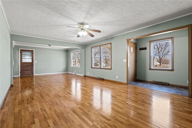 unfurnished living room with visible vents, a textured ceiling, wood finished floors, and a ceiling fan