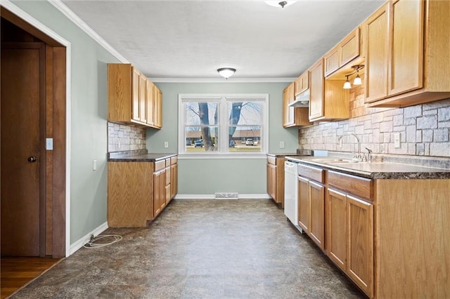 kitchen featuring crown molding, baseboards, under cabinet range hood, white dishwasher, and a sink