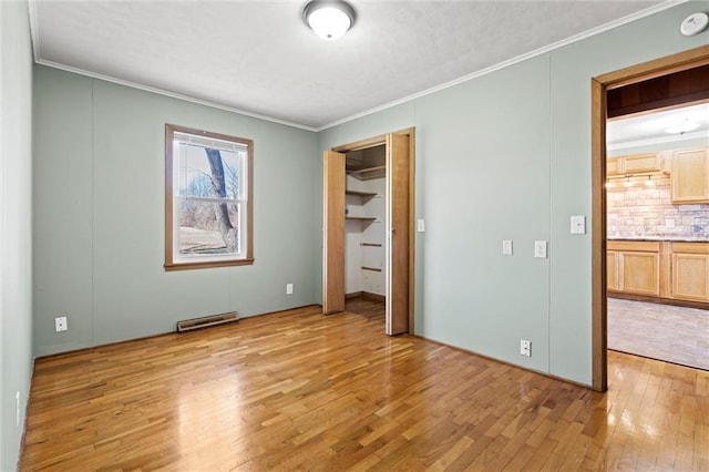 unfurnished bedroom featuring light wood-type flooring, visible vents, and ornamental molding