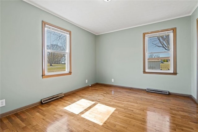 unfurnished room with light wood-style flooring, a healthy amount of sunlight, and visible vents