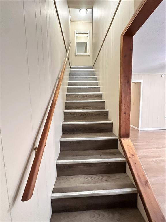 stairs with wood finished floors