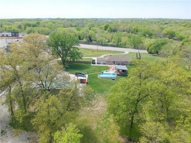 birds eye view of property featuring a wooded view