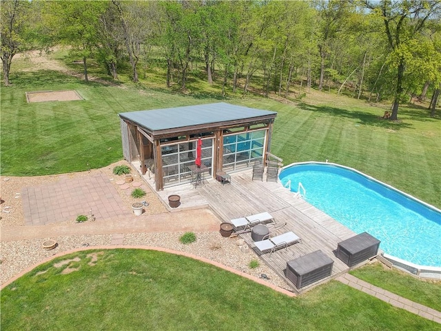 outdoor pool featuring an outbuilding and a yard