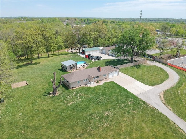 drone / aerial view with a wooded view