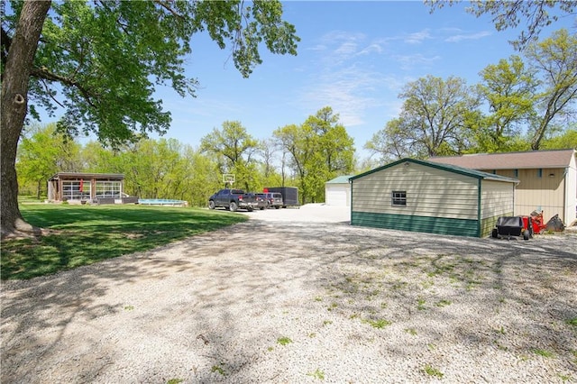 exterior space featuring a yard and an outbuilding