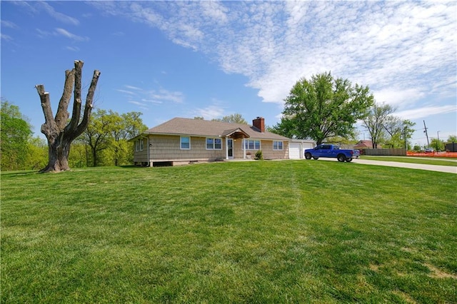 ranch-style house with a garage and a front lawn