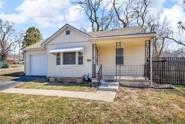 bungalow featuring driveway, a porch, fence, board and batten siding, and an attached garage