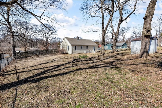 view of yard with an outbuilding and a fenced backyard