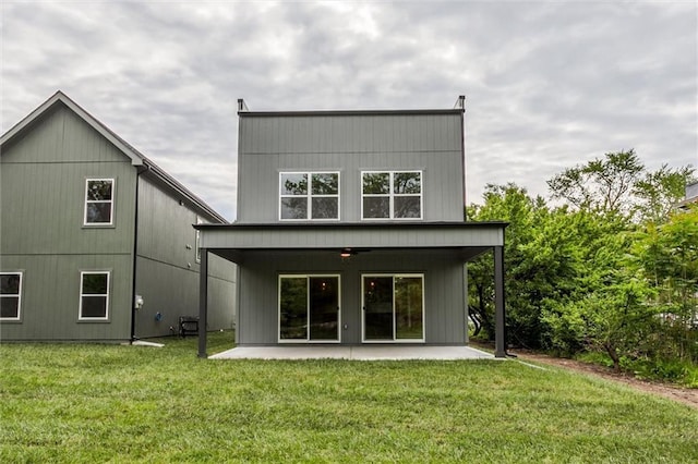 3322 Tracy Ave, Kansas City, MO 64109 - rear view of property featuring a patio, a ceiling fan, and a yard