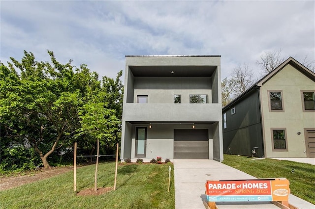 3322 Tracy Ave, Kansas City, MO 64109 - contemporary house featuring a front yard, driveway, and an attached garage
