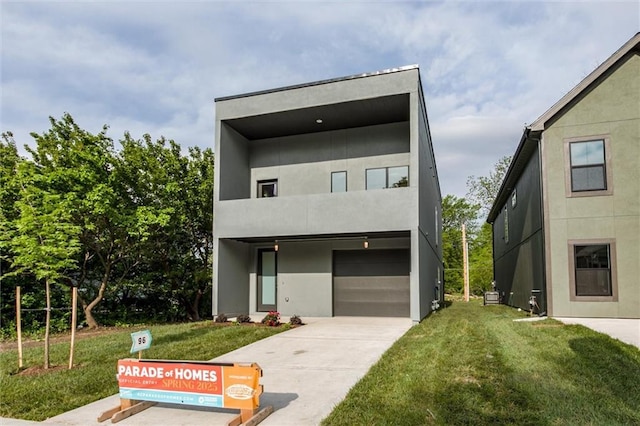 3322 Tracy Ave, Kansas City, MO 64109 - modern home featuring a front yard, a garage, driveway, and stucco siding