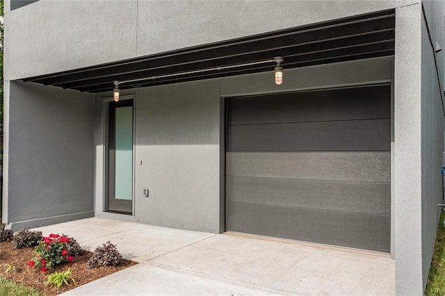 3322 Tracy Ave, Kansas City, MO 64109 - property entrance with a garage and stucco siding