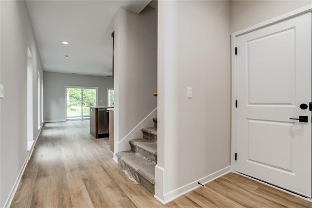 3322 Tracy Ave, Kansas City, MO 64109 - entryway featuring light wood-style floors, baseboards, stairs, and recessed lighting