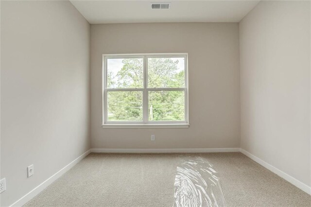 3322 Tracy Ave, Kansas City, MO 64109 - unfurnished room with light carpet and baseboards