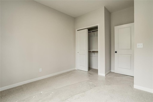 3322 Tracy Ave, Kansas City, MO 64109 - unfurnished bedroom featuring baseboards, a closet, and light carpet