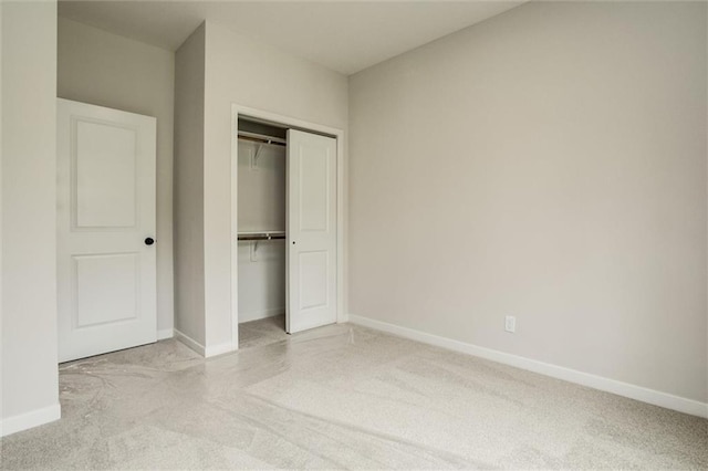 3322 Tracy Ave, Kansas City, MO 64109 - unfurnished bedroom with a closet, baseboards, and carpet floors