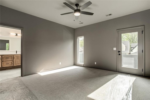 3322 Tracy Ave, Kansas City, MO 64109 - unfurnished room featuring light carpet, healthy amount of natural light, and a ceiling fan