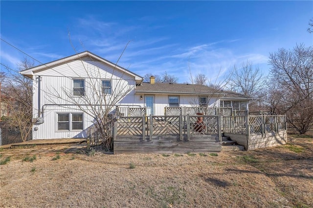 rear view of property featuring a deck