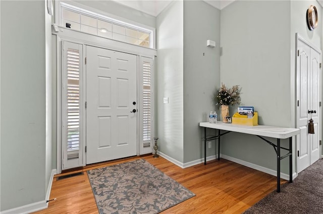 entrance foyer featuring light wood-style floors, baseboards, and visible vents