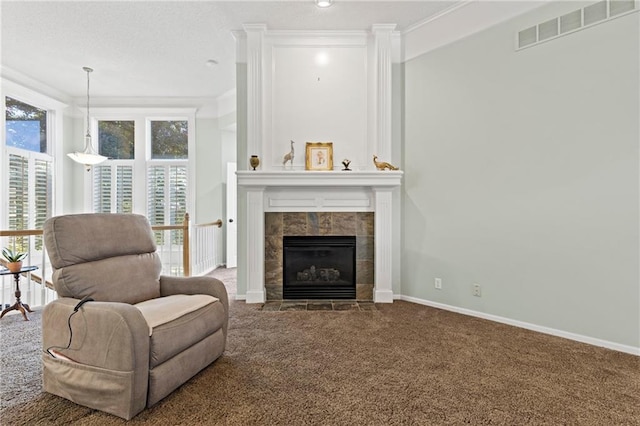 living area featuring ornamental molding, visible vents, a fireplace, and carpet flooring