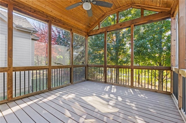 unfurnished sunroom with lofted ceiling, wood ceiling, and ceiling fan