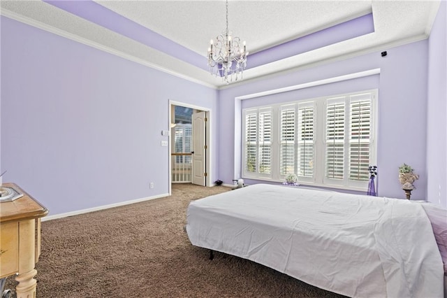 carpeted bedroom featuring baseboards, a chandelier, a raised ceiling, and a textured ceiling