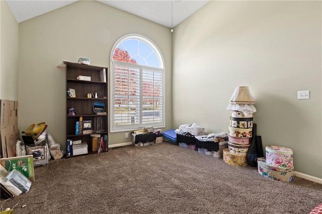 recreation room featuring carpet floors, baseboards, and vaulted ceiling