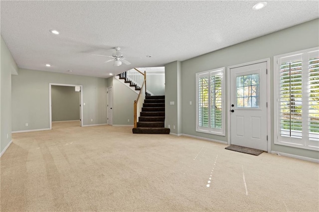 entrance foyer with light carpet, stairway, recessed lighting, and a healthy amount of sunlight