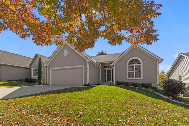 ranch-style home featuring a front lawn, driveway, an attached garage, and stucco siding