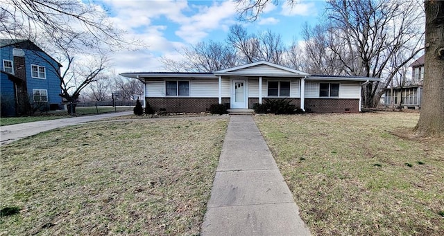 view of front of home featuring a front yard, brick siding, and fence