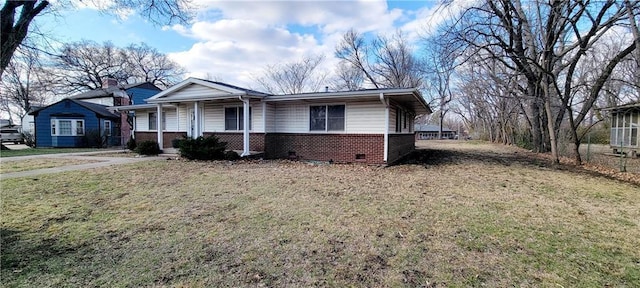 view of front of house featuring crawl space, a porch, a front lawn, and brick siding