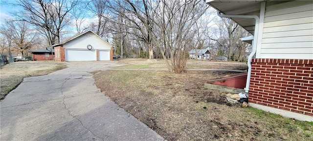 view of yard with a detached garage and an outdoor structure