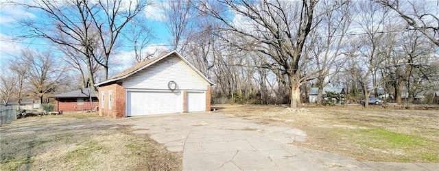 view of side of property with a garage and brick siding