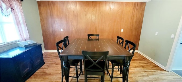 dining area featuring baseboards and wood finished floors