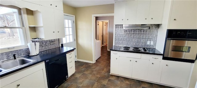 kitchen with tasteful backsplash, dark countertops, under cabinet range hood, black appliances, and a sink