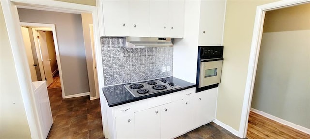 kitchen featuring under cabinet range hood, electric cooktop, stainless steel oven, white cabinets, and tasteful backsplash