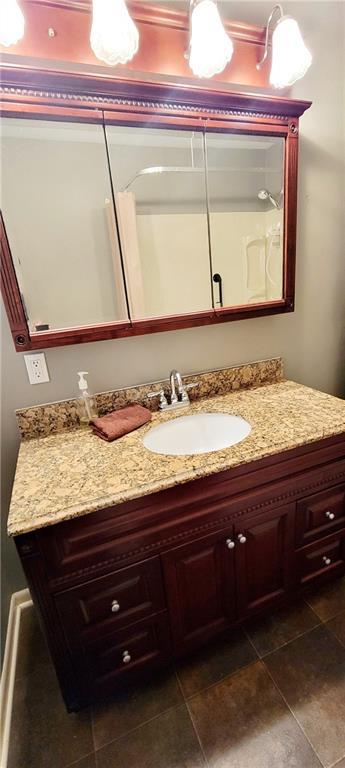 bathroom with tile patterned floors and vanity