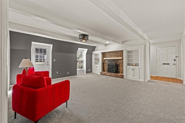 living room with beamed ceiling, built in shelves, a fireplace, carpet flooring, and baseboards