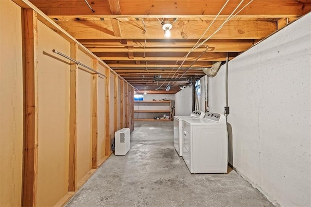 unfinished basement with washing machine and clothes dryer