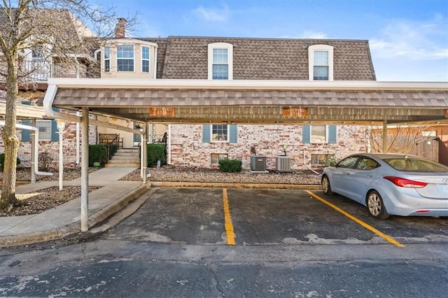 covered parking lot featuring stairway