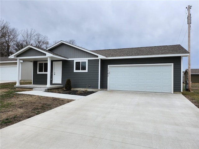 ranch-style home featuring a porch, roof with shingles, driveway, and an attached garage