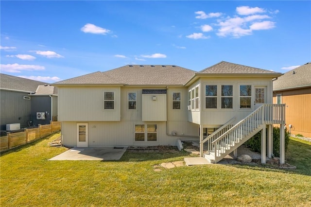 rear view of house featuring a patio area, stairs, a yard, and fence