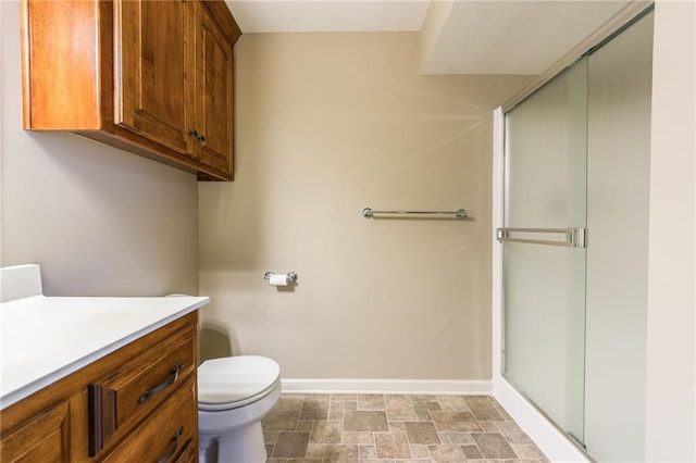 full bathroom featuring a stall shower, toilet, and baseboards