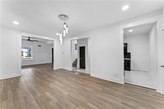 interior space with a ceiling fan, light wood-type flooring, baseboards, and recessed lighting